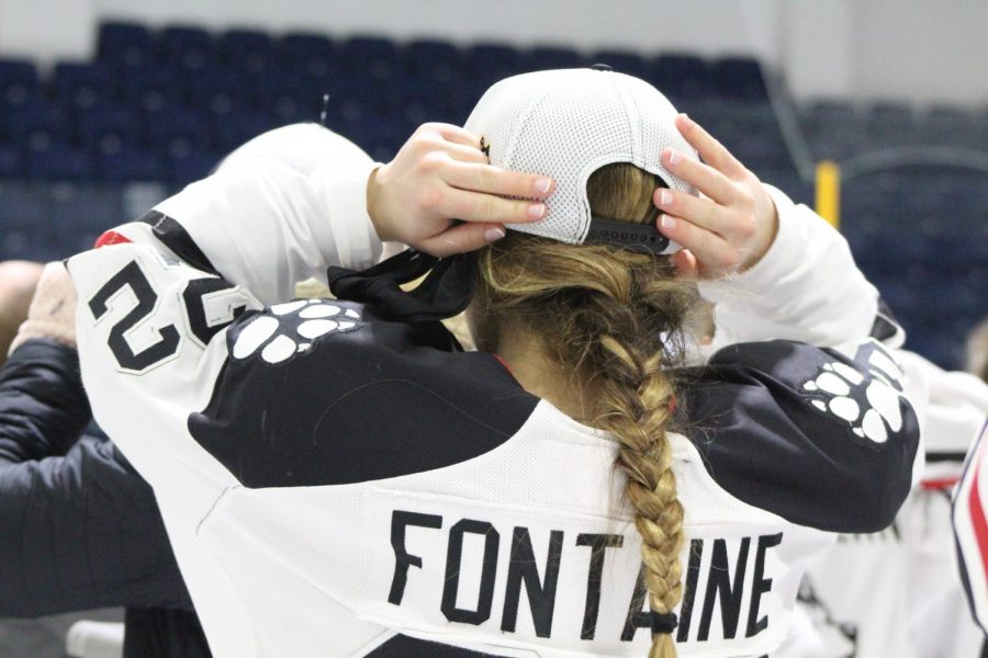 Fontaine straps on her championship hat. The junior blueliner scored three goals over championship weekend. 