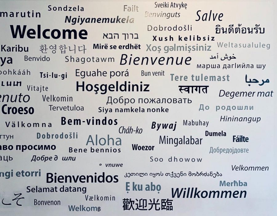 A wall in the Office of Global Services depicting a greeting in numerous languages.