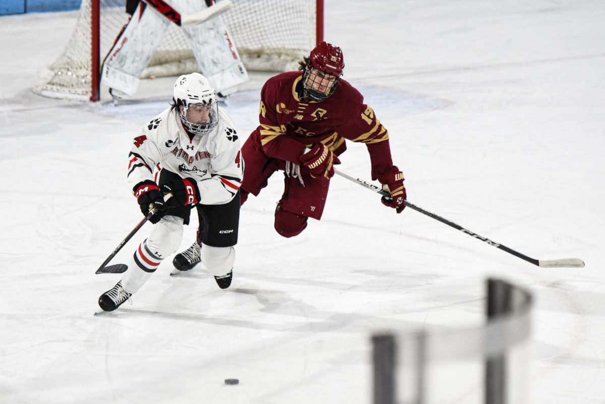 Pito Walton races against BC's Cutter Gauthier in Matthews Arena. Northeastern fell in the home ice game 3-1. 