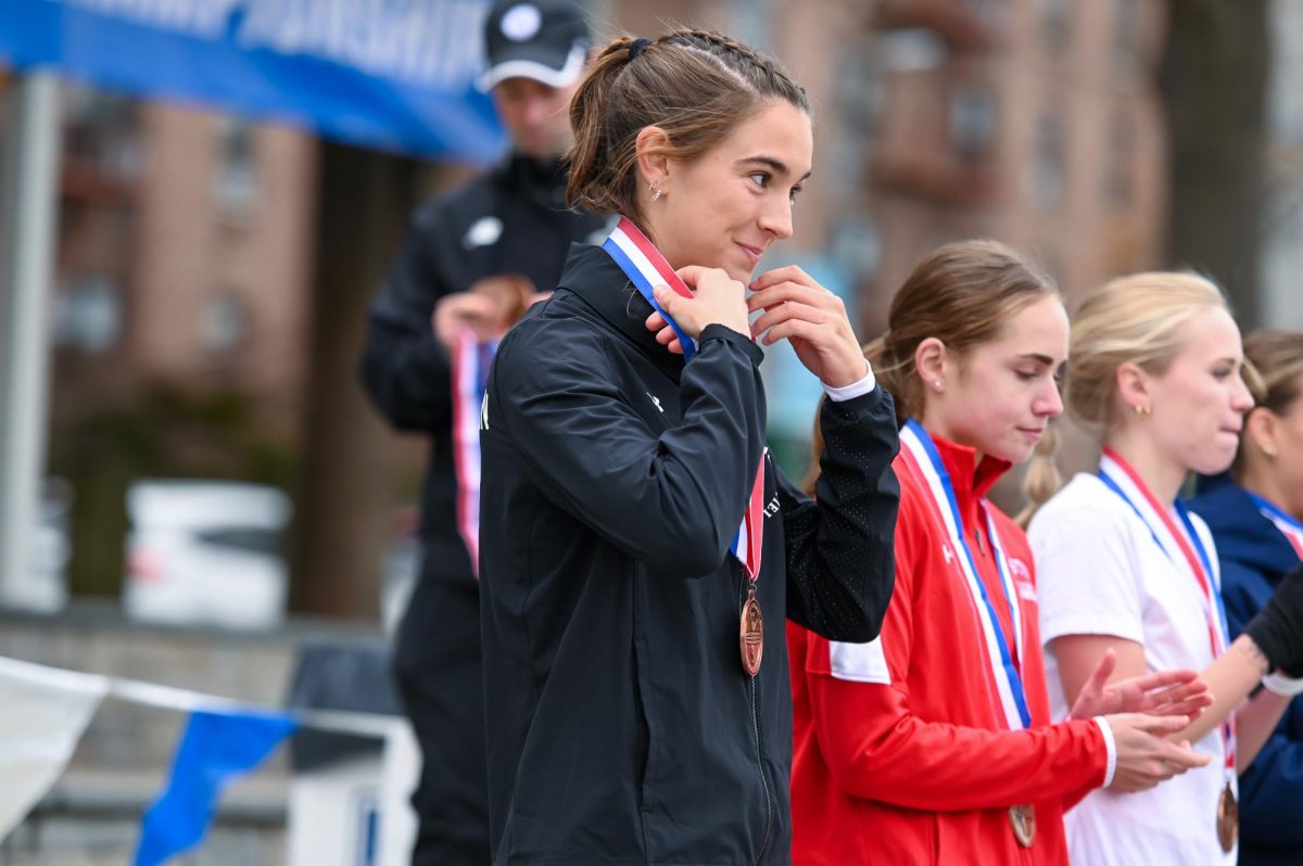 Abigail Hassman receives a medal for her performance at the NCAA Northeast Regional Championships. Hassman claimed fourth place in the women's race with a time of 19:57.5. Photo courtesy Northeastern Athletics