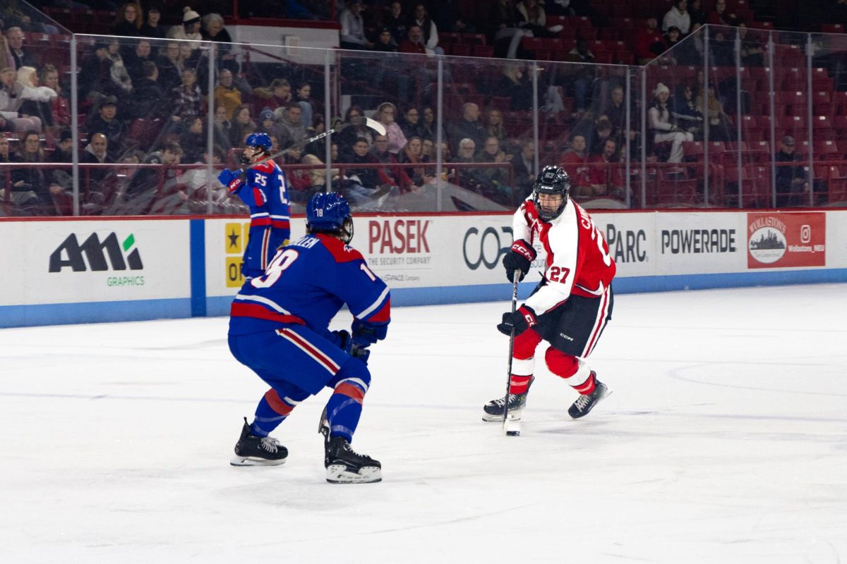 Alex Campbell looks for a way around Lowell's Sean Kilcullen. Campbell scored Northeastern's second goal of the night, assisted by both Hryckowian brothers.