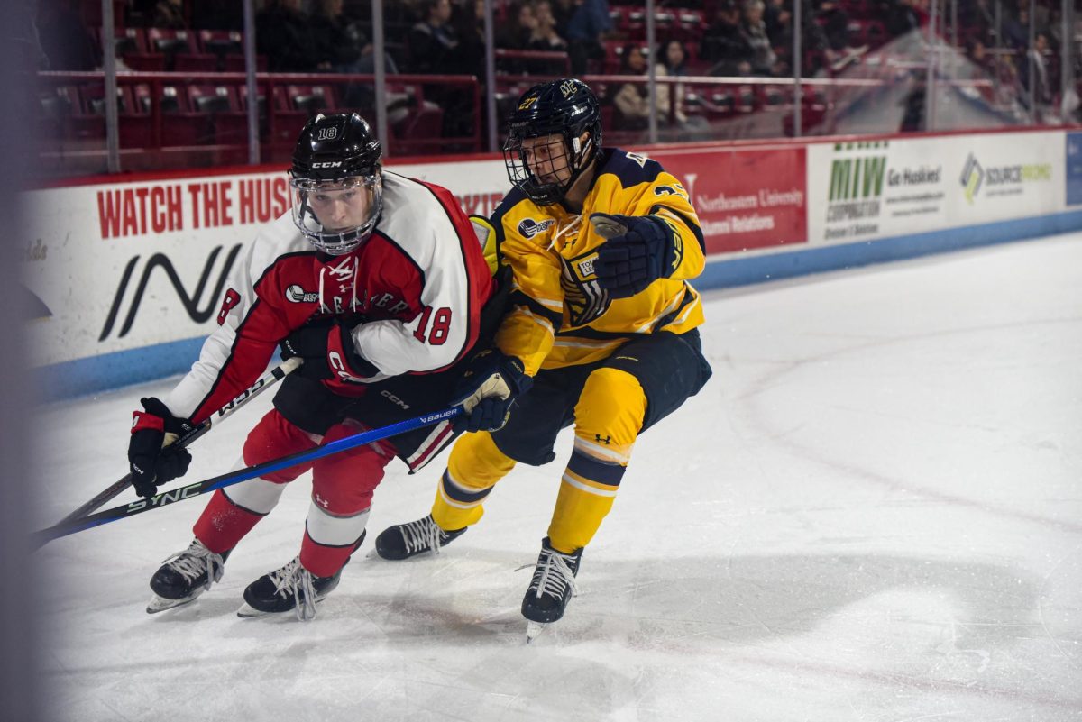 Freshman forward Andy Moore chases down the forecheck for Northeastern. The Huskies defeated Merrimack 4-0 in the first postseason shutout in program history. 