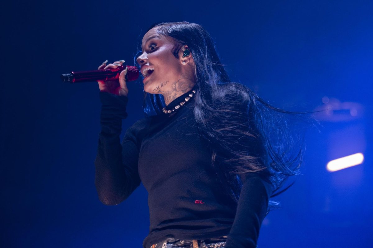 Kehlani sings into a red microphone. She performed as the headliner for CUP's annual Springfest concert after finishing a 54-show world tour.