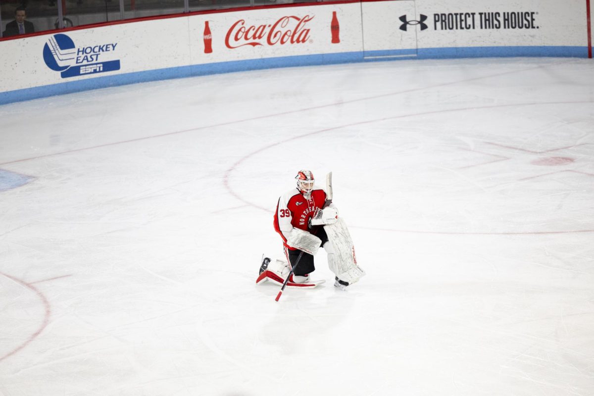 Cameron Whitehead kneels during a game intermission. Whitehead recorded a career high of 57 saves against the University of Maine.