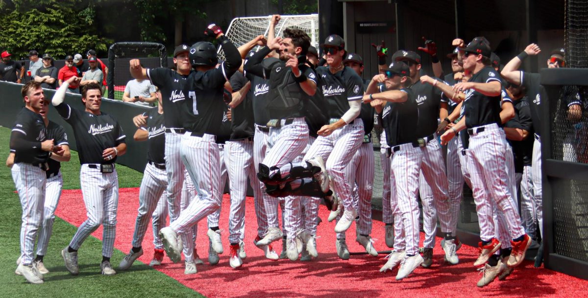 The Huskies celebrate May 16. Northeastern won against the College of Charleston 6-0 with their 17th shutout of the season, the most in the nation.
