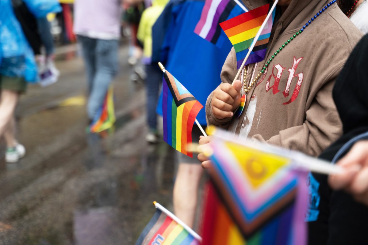 Attendees wave pride flags at Boston’s Pride For The People festival and parade June 14. Pride demonstrations first began as a response to the widespread harassment and discrimination of LGBTQ+ communities across North America.